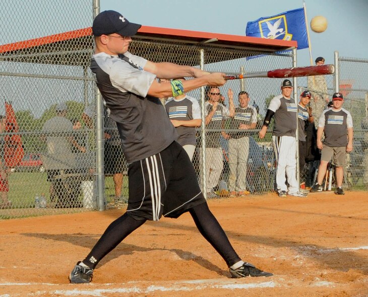Cory Donelson, from the 2nd Security Forces Squadron softball team, hits a fly ball in the top of the fourth inning at Barksdale Air Force Base, La., June 15, 2016. Donelson scored one of his team's seven runs that inning. (U.S. Air Force photo/Airman First Class Stuart Bright)