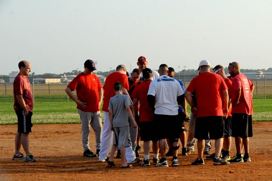 The Air Force Global Stike Command softball team huddle up after their game at Barksdale Air Force Base, La., June 15, 2016. AFGSC won 16-9 against the 2nd Security Forces Squadron. (U.S. Air Force photo/Airman First Class Stuart Bright)