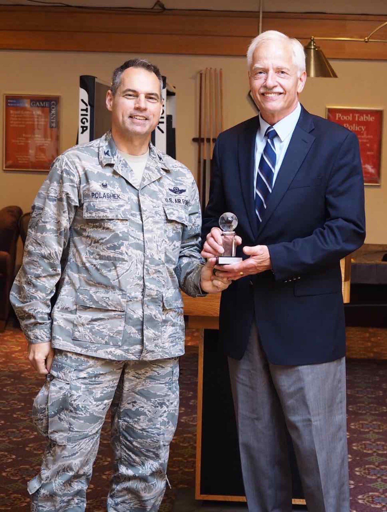 Mr. Jeff Hamiel is inducted into the Order of the Global Vikings as Col. Tony Polashek, 934th Airlift Wing commander, presents him with the crystal globe commemorating the event. For more than 35 years Hamiel has been an advocate for the 934th through his work as CEO of the Metropolitan Airports Commission. Hamiel also served for 20 years as a reservist at the 934th retiring after serving as the 96th Airlift Squadron commander. (Air Force Photo/Paul Zadach)

