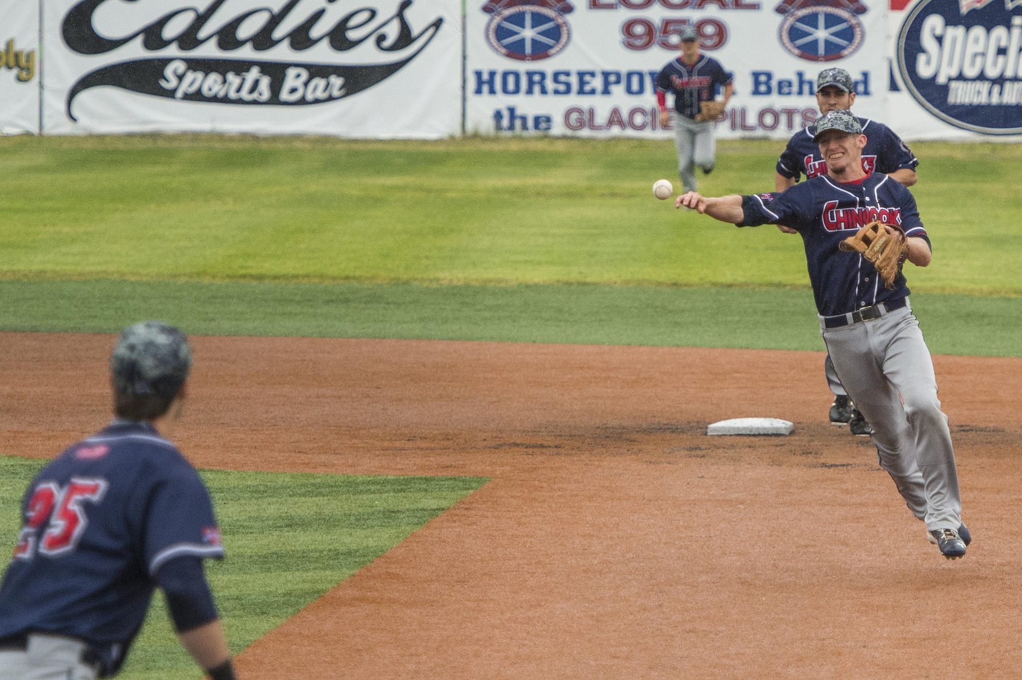 Chugiak-Eagle River Chinooks infielder Will Bass, throws to first base during the Anchorage Bucs Military Appreciation Game at Mulcahy Stadium in Anchorage, Alaska, June 19, 2016.  (U.S. Air Force photo by Senior Airman James Richardson/Released)
