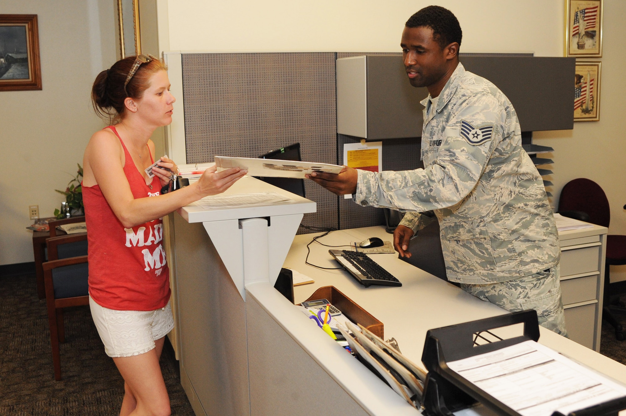 Staff Sgt. Wesley Ramsey, 2nd Logistics Readiness Squadron personal property counselor, goes over the process of moving household goods for a retired member at the Traffic Management Office on Barksdale Air Force Base, La., June 17, 2016. Ramsey ensured all information was correct on her DD Form 2278 to assist with the move of her property. (U.S. Air Force photo/Airman Alexis Frost)
