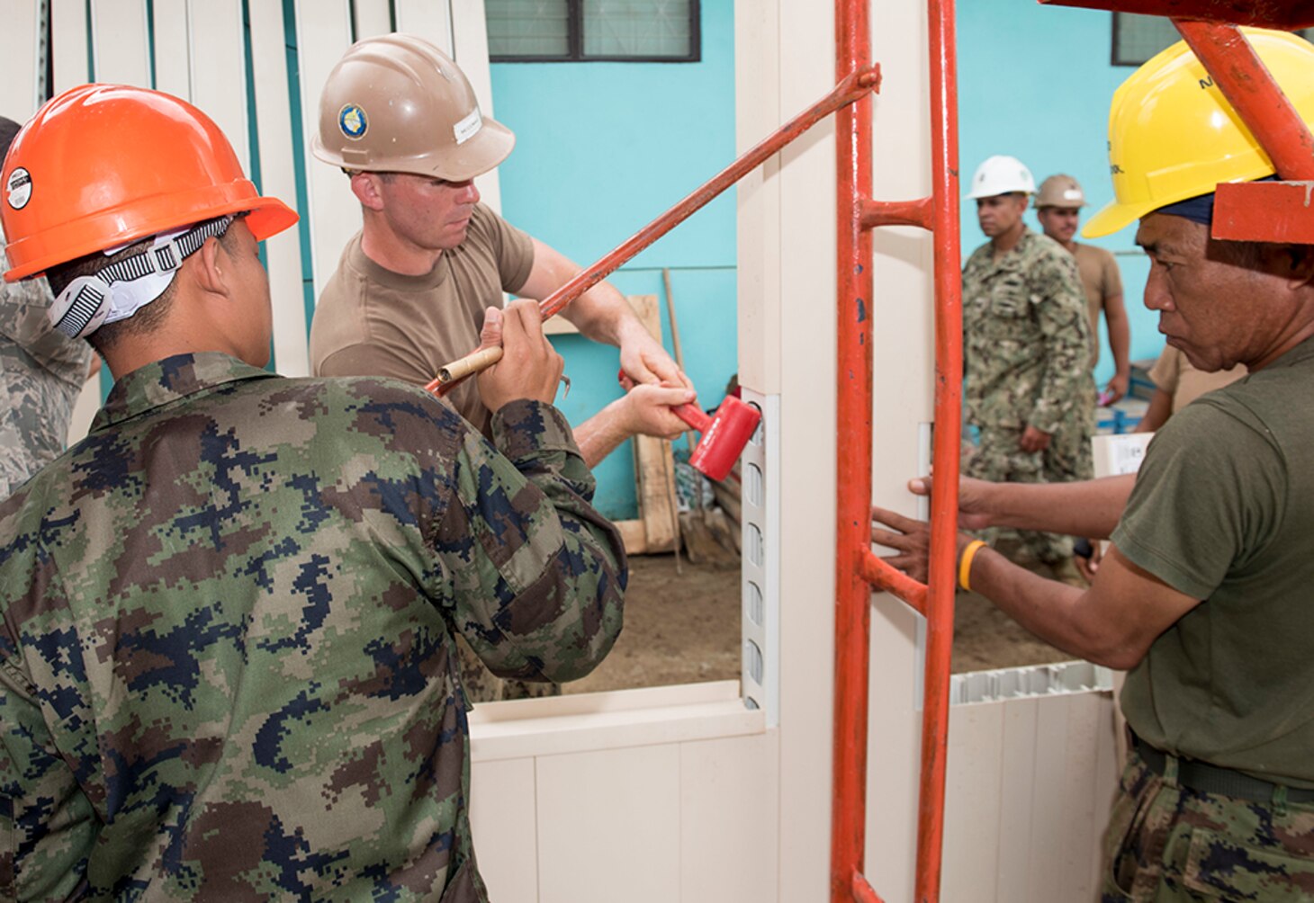 SATTAHIP, Thailand (June 21, 2016) Equipment Operator Constructionman Daniel McComas from Naval Mobile Construction Battalion (NMCB) 4 hammers construction pieces into place with Royal Thai Navy Seabees while building a library at Khao Chi Chan School during Cooperation Afloat Readiness and Training (CARAT) Thailand 2016. CARAT is a series of annual maritime exercises between the U.S. Navy, U.S. Marine Corps and the armed forces of nine partner nations to include Bangladesh, Brunei, Cambodia, Indonesia, Malaysia, the Philippines, Singapore, Thailand, and Timor-Leste. 