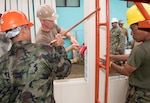 SATTAHIP, Thailand (June 21, 2016) Equipment Operator Constructionman Daniel McComas from Naval Mobile Construction Battalion (NMCB) 4 hammers construction pieces into place with Royal Thai Navy Seabees while building a library at Khao Chi Chan School during Cooperation Afloat Readiness and Training (CARAT) Thailand 2016. CARAT is a series of annual maritime exercises between the U.S. Navy, U.S. Marine Corps and the armed forces of nine partner nations to include Bangladesh, Brunei, Cambodia, Indonesia, Malaysia, the Philippines, Singapore, Thailand, and Timor-Leste. 