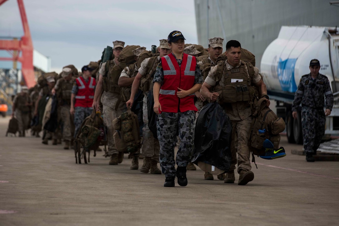 U.S. Marines prepare to go aboard the HMAS Adelaide at Port of Brisbane, Queensland, Australia, June 16, 2016. This marks the first time Marines and sailors from Marine Rotational Force - Darwin have embarked in such numbers on an Australian HMAS. This opportunity allows for MRF-D to expand the partnership capabilities with our Australian allies. The Marines are with 1st Battalion, 1st Marine Regiment, MRF-D, and the Australians are with HMAS Adelaide.