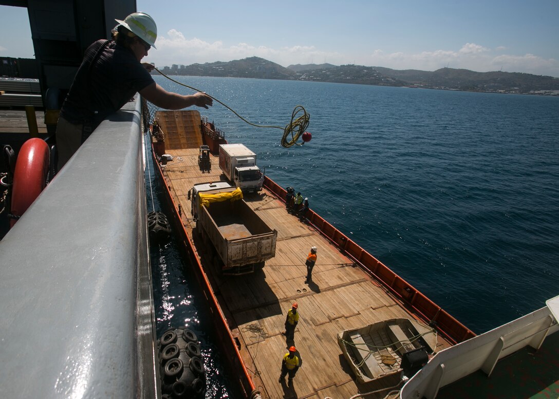 A crew member aboard USNS Sacagawea (T-AKE 2) throws a line to a barge as part of the process of preparing to move supplies from ship to ship. Sacagawea is a Marine Prepositioning Force ship responsible for transporting Task Force Koa Moana to various countries in the Asia-Pacific region to support their mission to increase interoperability and relations. The Marines and Sailors with the task force are originally assigned to I and III Marine Expeditionary Force. 