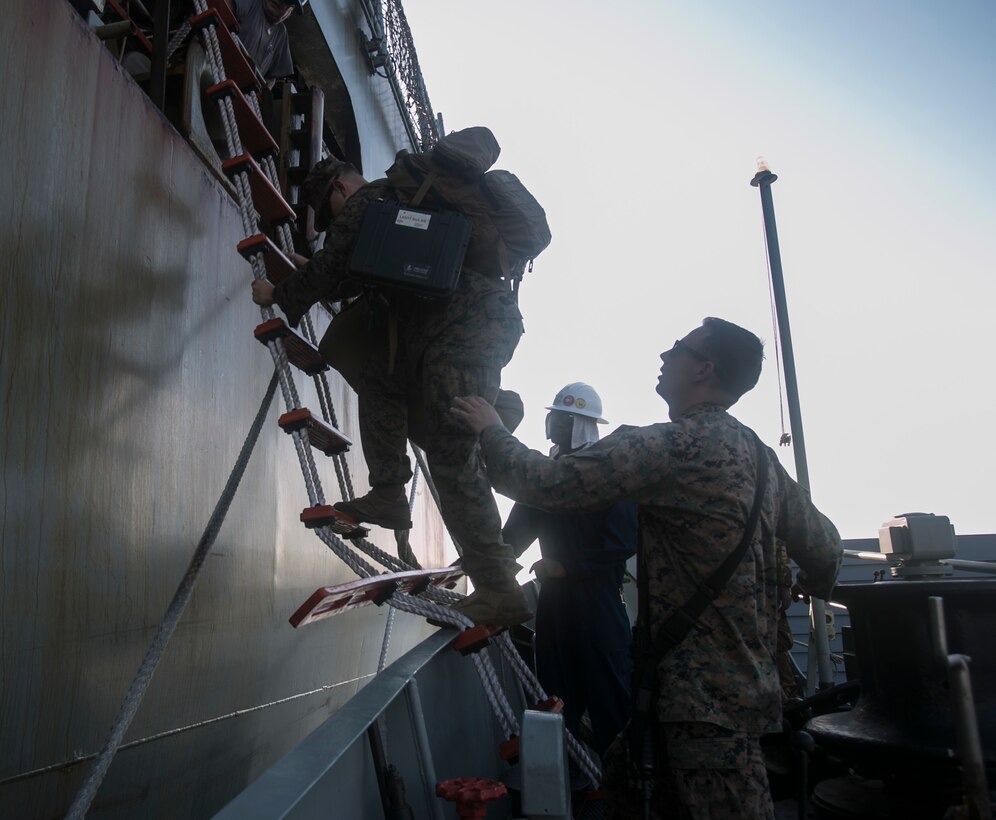 Cpl. Zachary A. Barnett (Right) assists a fellow Marine onto a Papua New Guinea naval vessel, as part of their movement to shore from USNS Sacagawea (T-AKE 2), to participate in Exercise Koa Moana, June 17, 2016, as part of Task Force Koa Moana’s deployment in the Asia-Pacific region. Koa Moana is a multi-national, bilateral exercise with the Papua New Guinea Defence Force to increase interoperability and relations by sharing infantry, law enforcement, medical and engineering skills. The Sacagawea is a Marine Prepositioning Force Ship assigned to transport the task force to multiple nations in the Asia-Pacific region during their deployment. This marks the first time for the Papua New Guinea Navy to transport equipment and personnel from ship to ship to shore. The U.S. service members with the task force are originally assigned to I and III Marine Expeditionary Force. 
