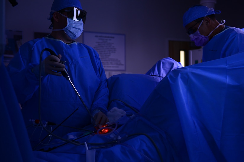 U.S. Air Force Capt. Stuart Winkler, left, 633rd Medical Operations Squadron obstetrician, uses a 3-D scope and glasses while performing a hysterectomy at Langley Air Force Base, Va., June 14, 2016. The 3-D technology is new in the operating rooms at Langley which gives surgeons accuracy, speed and precision during surgical tasks. (U.S. Air Force photo by Staff Sgt. Ciara Gosier)