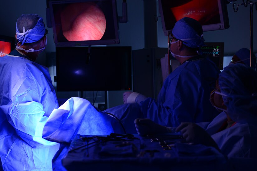 U.S. Air Force Maj. Arthur Greenwood and Capt. Stuart Winkler, 633rd Medical Operations Squadron obstetricians, use a 3-D scope and glasses while performing a hysterectomy at Langley Air Force Base, Va., June 14, 2016. The 3-D technology is new in the operating rooms at Langley and gives surgeon a better view of what is happening surgically. (U.S. Air Force photo by Staff Sgt. Ciara Gosier)