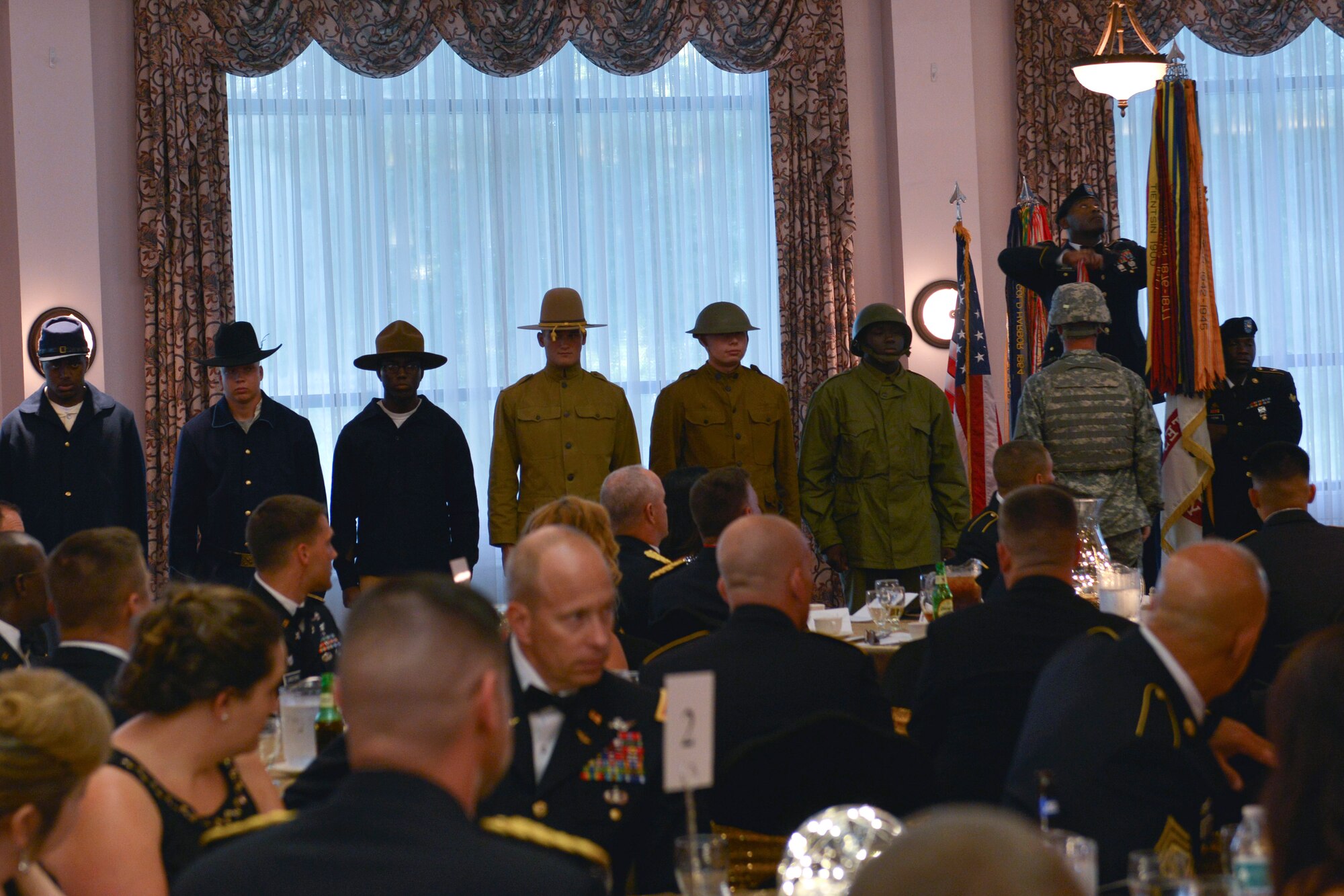 U.S. Army Command Sgt. Major. James H. Jackson, 733rd Mission Support Group command sergeant major, adds a battle streamer to the Army guidon during the Army Ball at Fort Eustis, Va., June 17, 2016. Each streamer represented a campaign that the Army has fought in, dating from the Revolutionary War to present day. (U.S. Air Force photo by Staff Sgt. Natasha Stannard)