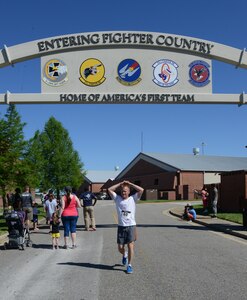 U.S. Air Force Chief Master Sgt. Mark Hurst, 633rd Air Base Wing command chief, crosses the finish line of the Langley Chapter Air Force Association Wounded Airman Program 5K at Langley Air Force Base, Va., June 18, 2016. The 5K route included a section of the flight line where runners could view F-22A Raptors on display during the run. (U.S. Air Force photo by Staff Sgt. Teresa J. Cleveland)