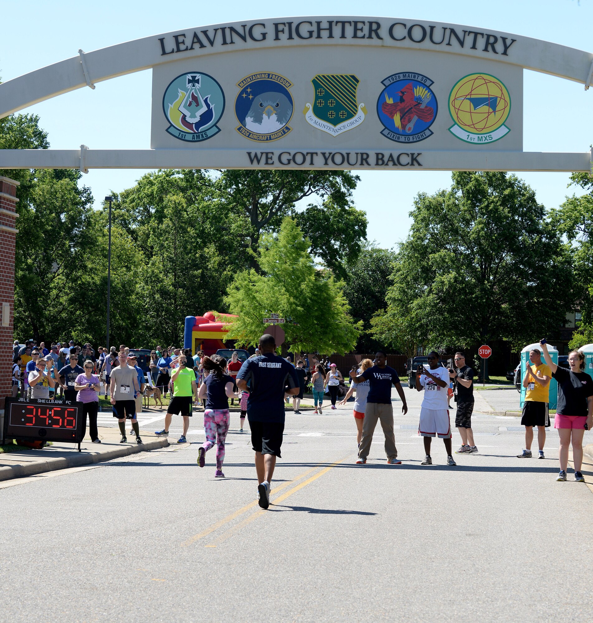 Runners in the Langley Chapter Air Force Association Wounded Airman Program 5K reach the finish line at Langley Air Force Base, Va., June 18, 2016. More than 250 people participated in the event. (U.S. Air Force photo by Staff Sgt. Teresa J. Cleveland)