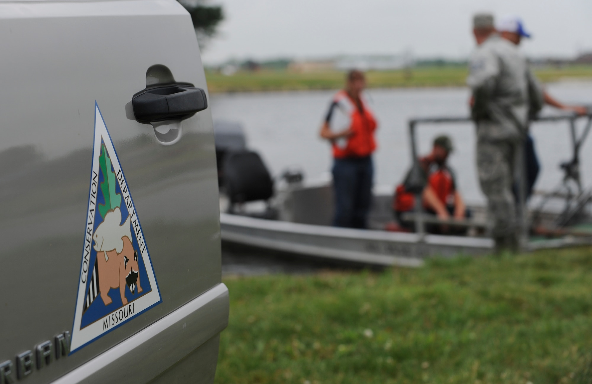 Members of the 509th Civil Engineer Squadron and Missouri Department of Conservation prepare to inspect fish samples they collected from Ike Skelton Lake using electrofishing at Whiteman Air Force Base, Mo., June 21, 2016. Electrofishing uses two electrodes, a cathode and an anode, which draw the fish closer to the boat, making it easier for them to be caught by a net. (U.S. Air Force photo by Senior Airman Danielle Quilla)