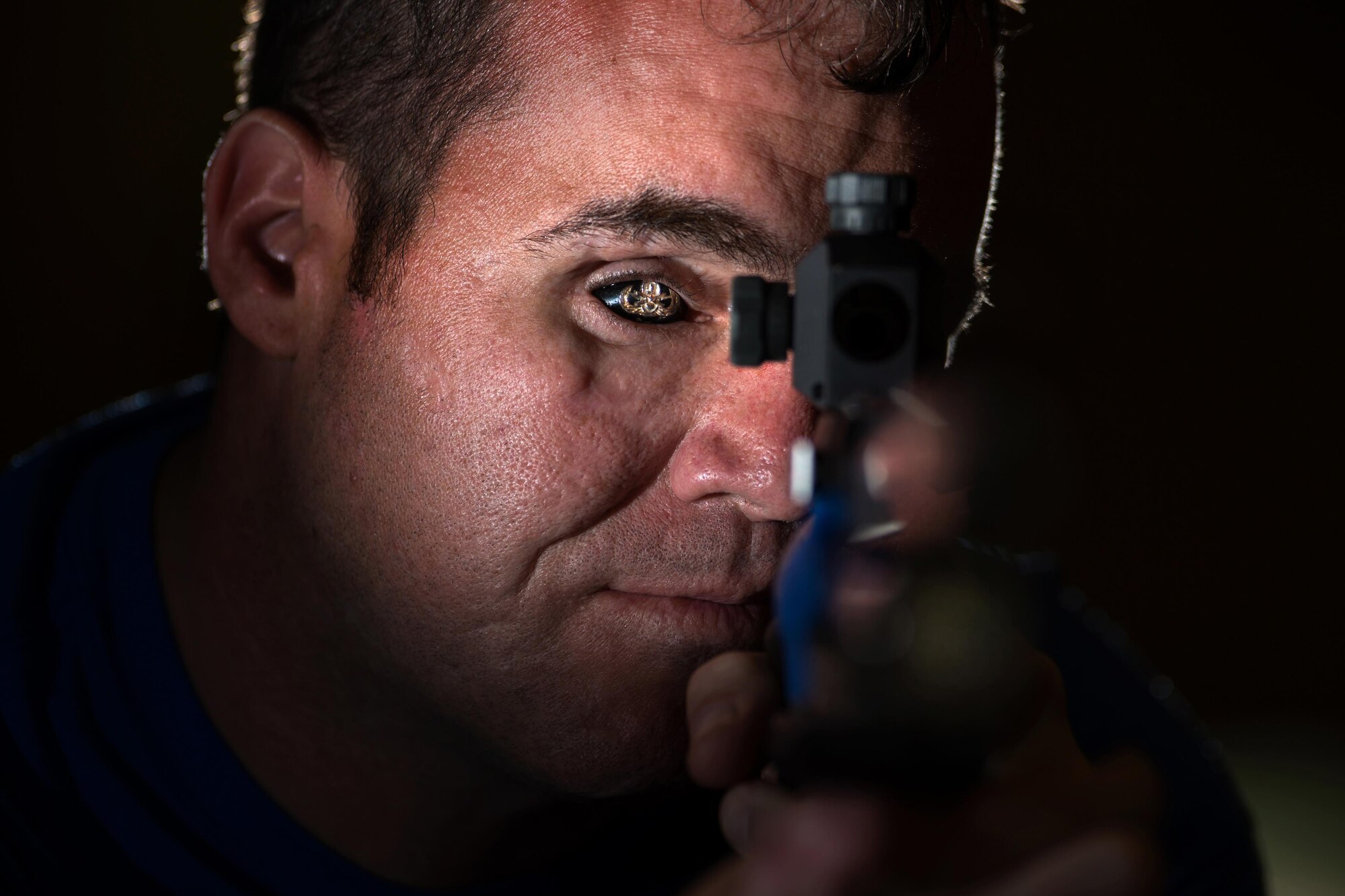 Former Master Sgt. Reese Hines poses for a photo with a competition air rifle at the U.S. Military Academy in West Point, N.Y., June 19, 2016. Hines was named the event’s Ultimate Champion after winning a series of events. (Defense Department photo/EJ Hersom)