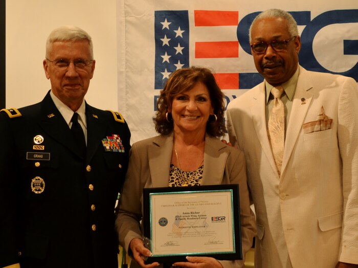 Former The Adjutant General—Pennsylvania retired Maj. Gen. Wesley Craig, Jr., and Southeast Area Chairman for the Pennsylvania Employer Support of the Guard Reserve Albert Newman, present a recognition award to Anna Richar, the Horsham Air Guard Station Airman & Family Readiness Center program manager, during an ESGR recognition and awards banquet held in Horsham, Pa., June 14, 2016. Craig served as the keynote speaker and was the 51st adjutant general for the state. (U.S. Air National Guard photo by Tech. Sgt. Andria Allmond)