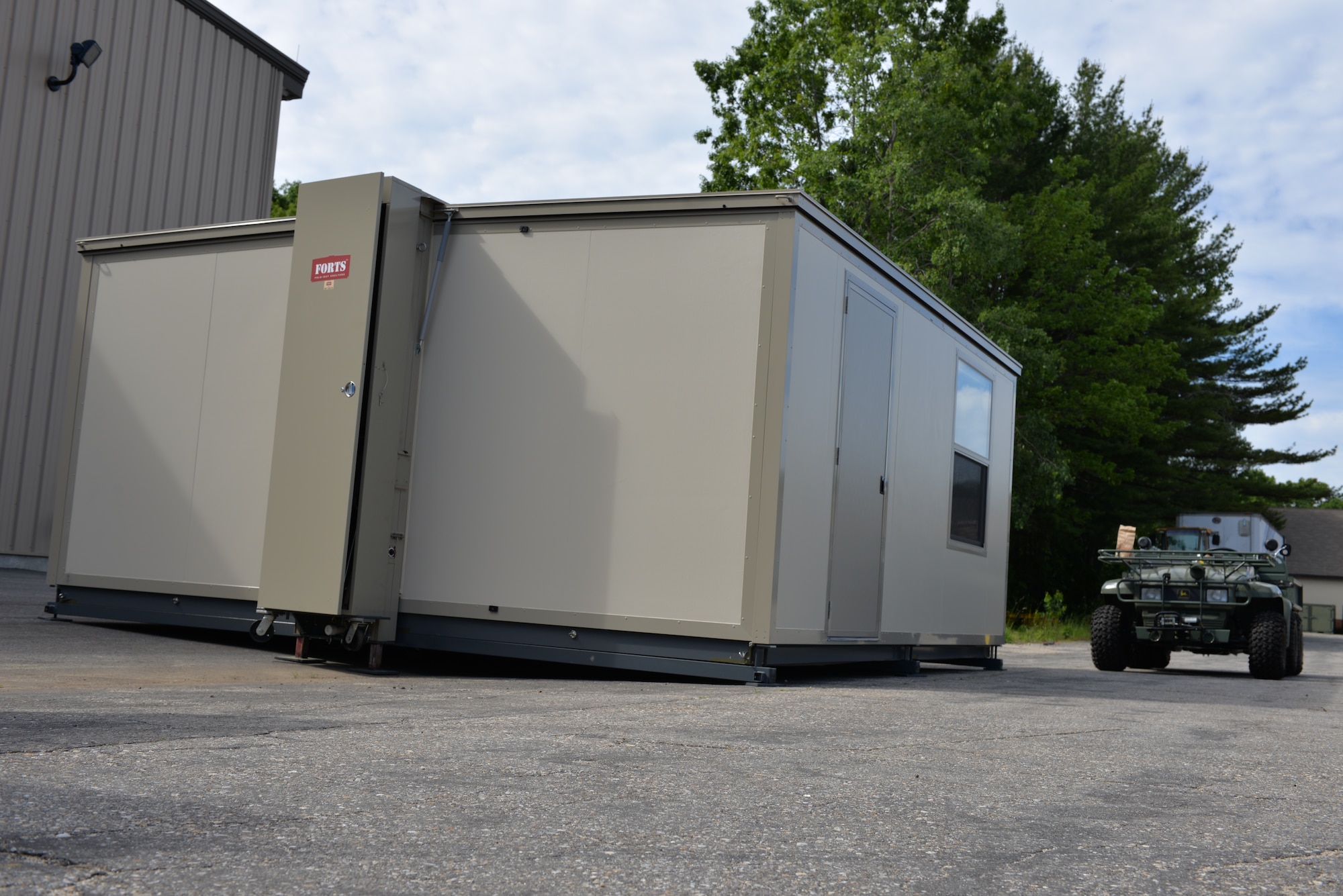 Members from the 157th Civil Engineering Squadron successfully built the FORTS (Fold-Out Rigid Temporary Shelters) structure at Pease Air National Guard Base, N.H., June 17.  The FORTS structure can be set up in less than 10 minutes, and are designed to withstand wind loads of over 100mph. (U.S. Air National Guard photo by Tech. Sgt. Erica Rowe)