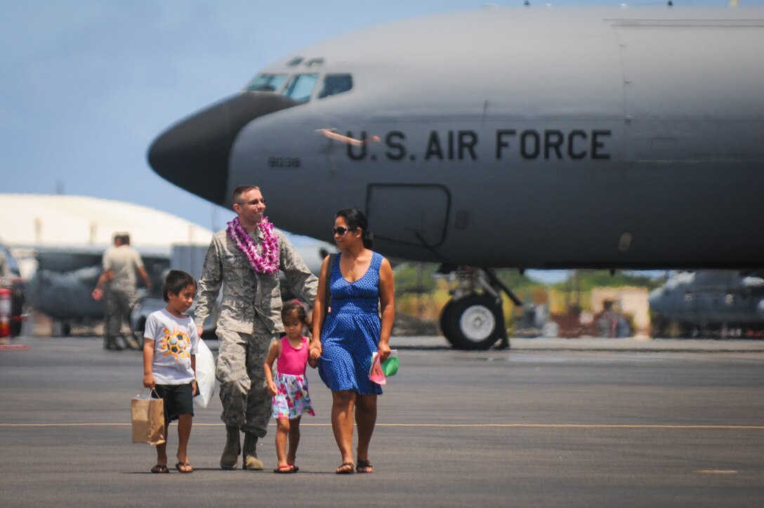 An airman from the Hawaii Air National Guard's 203rd Air Refueling Squadron greets his family upon his returning from deployment Jun. 16, 2016, Joint Base Pearl Harbor-Hickam. More than 50 service members, three KC-135 Stratotankers, flight and maintenance crews, and other support personnel were deployed for four months as part of an Air Expeditionary Force rotation. (U.S. Air National Guard photo by Airman 1st Class Robert Cabuco/released) 