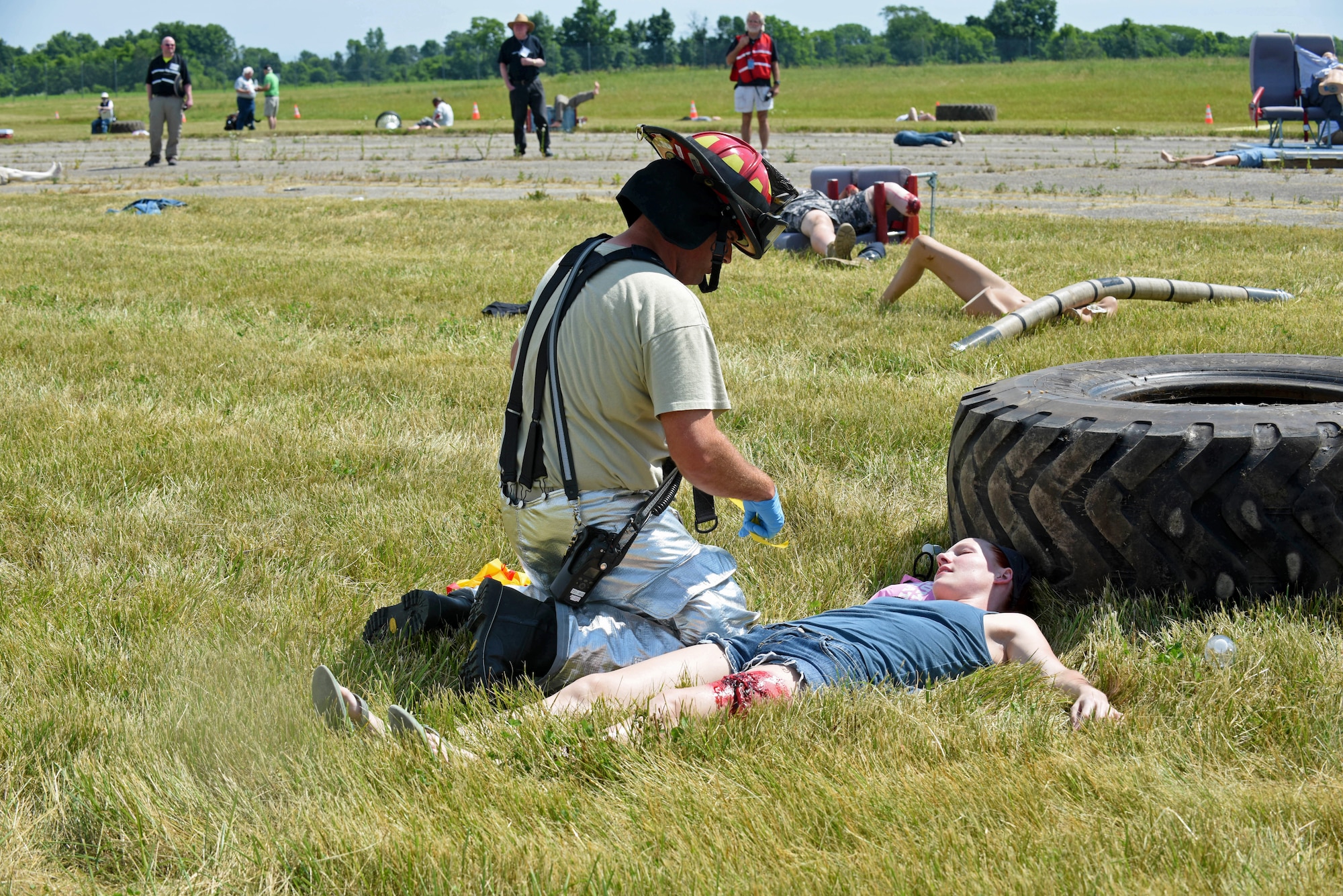 A U.S. Air Force Firefighter, with the 121st Civil Engineering Fire Department, tags an injured passenger according to medical assessment during a full-scale, mass casualty emergency preparedness exercise June 14, 2016 at Rickenbacker International Airport. The exercise was held to test and evaluate emergency response plans of the Columbus Regional Airport Authority, first response emergency services, hospitals, community non-profits and other local emergency preparedness organizations in the event of a major disaster. (U.S. Air National Guard photo by Airman 1st Class Ashley Williams/Released)