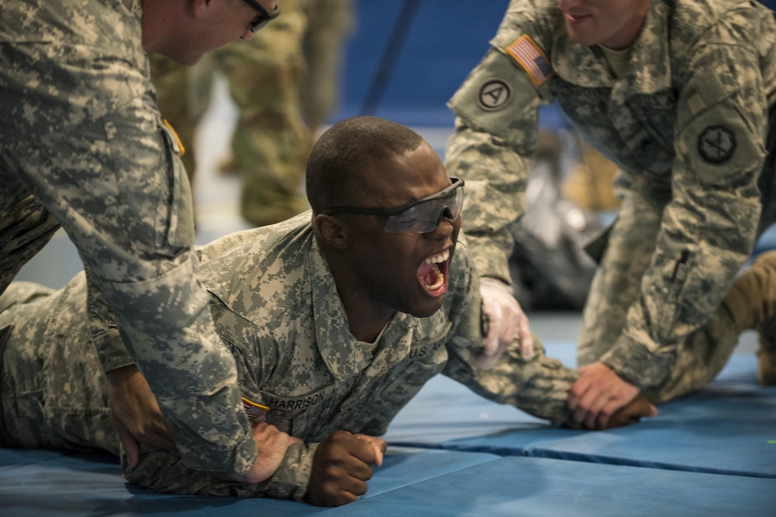 Army Pfc. Chauncey Harrison reacts while receiving a five-second pulse shot from an X26 Taser as part of a stun gun familiarization training event during Guardian Justice at Fort McCoy, Wisc., June 21, 2016. Guardian Justice is a military police training exercise focusing on combat support and detainee operations skills. Army photo by Master Sgt. Michel Sauret