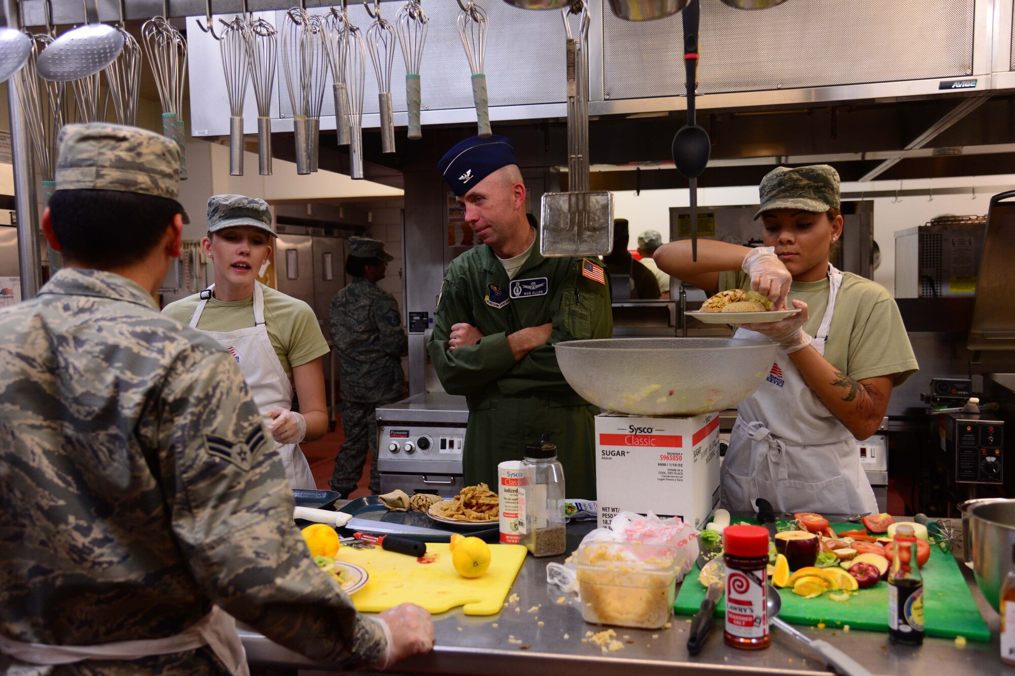 Col. Ron Allen, 341st Missile Wing commander, watches as a Warrior Chef Competition team finishes creating their contest meal June 22, 2016, at Malmstrom Air Force Base. Mont. The teams had 60 minutes to prepare their competition dish for the judges which included Allen, a local special guest and the vice wing commander. (U.S. Air Force photo/Airman 1st Class Magen M. Reeves) 