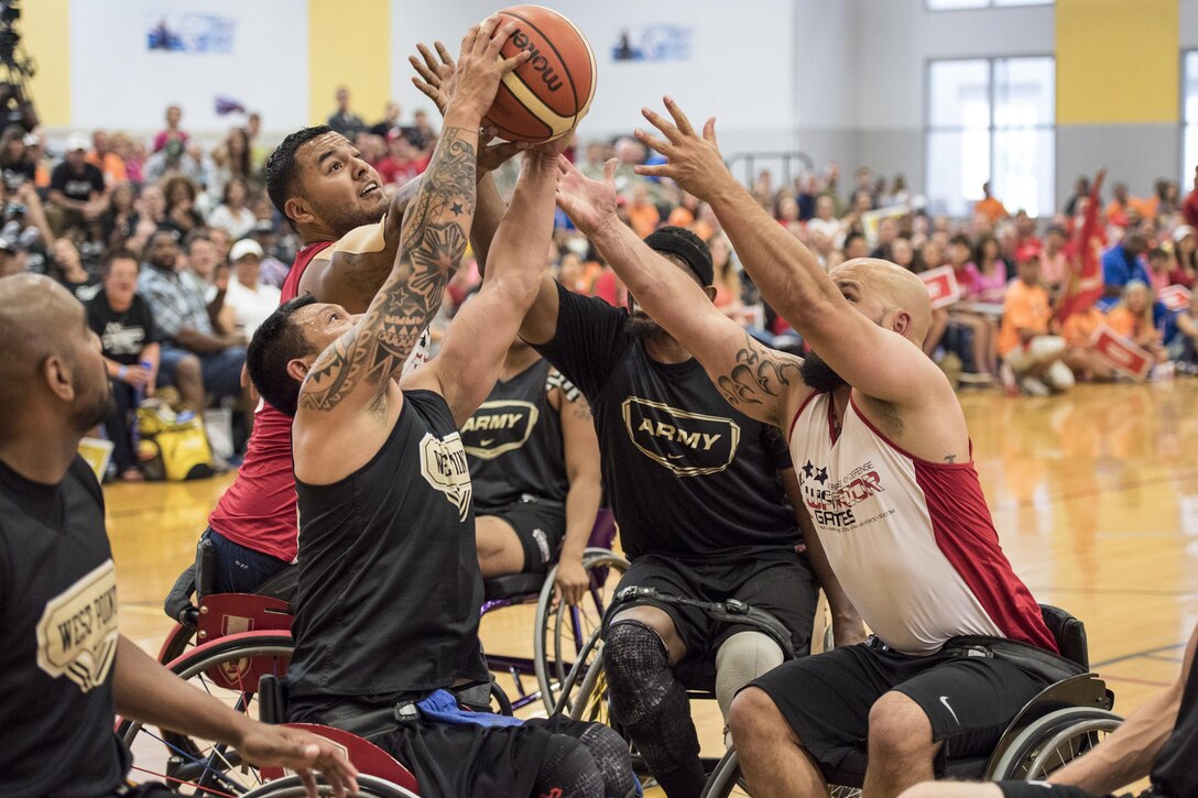 Left to right: Army veteran Delvin Matson, Army veteran Jhoonar Barrera, Marine Corps veteran Jorge Salazar, Army veteran Alexander Shaw and Marine Corps veteran Jeremy Lake grab for the ball as soldiers defeat Marines to win gold in wheelchair basketball during the 2016 Department of Defense Warrior Games at the U.S. Military Academy in West Point, N.Y., June 21, 2016. DoD photo by Roger Wollenberg