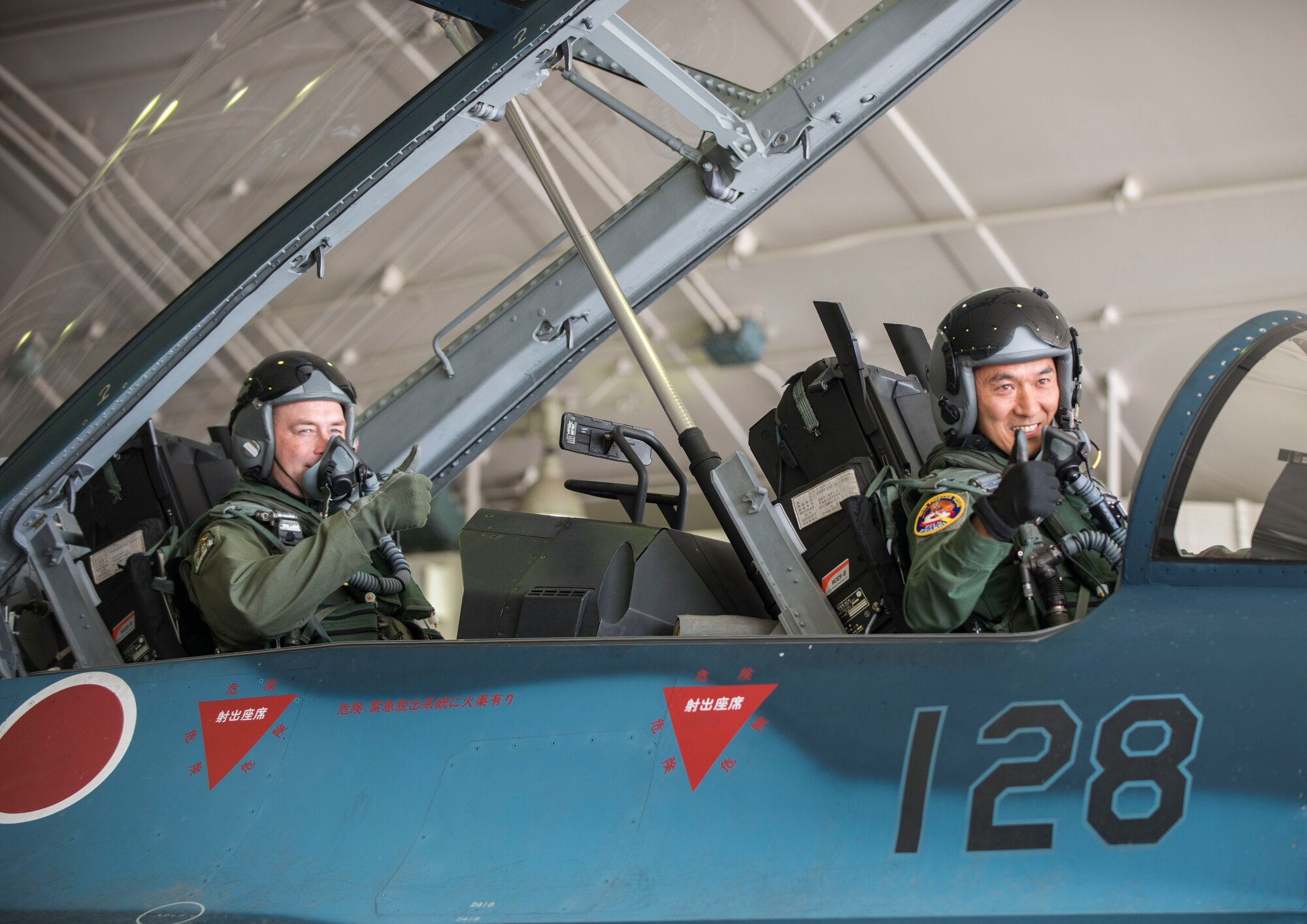 U.S. Air Force Col. Timothy Sundvall (left), the commander of the 35th Fighter Wing, and Japan Air Self-Defense Force Lt. Col. Mikio Kobayashi (right), the commander of the 3rd Fighter Squadron, give the "thumbs-up" in an F-2A at Misawa Air Base, Japan, June 22, 2016. Maj. Gen. Koji Imaki, the commander of the 3rd Air Wing, invited Sundvall to fly in an F-2A with the 3rd FS, giving him the unique opportunity to see firsthand how his bilateral counterparts operate in their day-to-day mission. (U.S. Air Force photo by Senior Airman Brittany A. Chase)