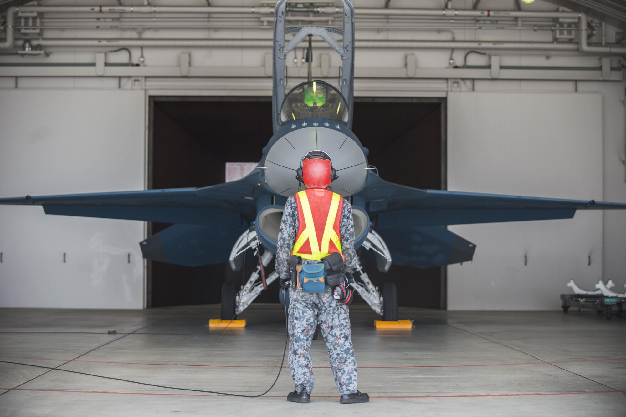A crew chief with the 3rd Fighter Squadron runs pre-flight checks at Misawa Air Base, Japan, June 22, 2016. U.S. Air Force Col. Timothy Sundvall, the commander of the 35th Fighter Wing was invited to fly in an F-2A with the 3rd FS, marking his first time flying in this aircraft. (U.S. Air Force photo by Senior Airman Brittany A. Chase)