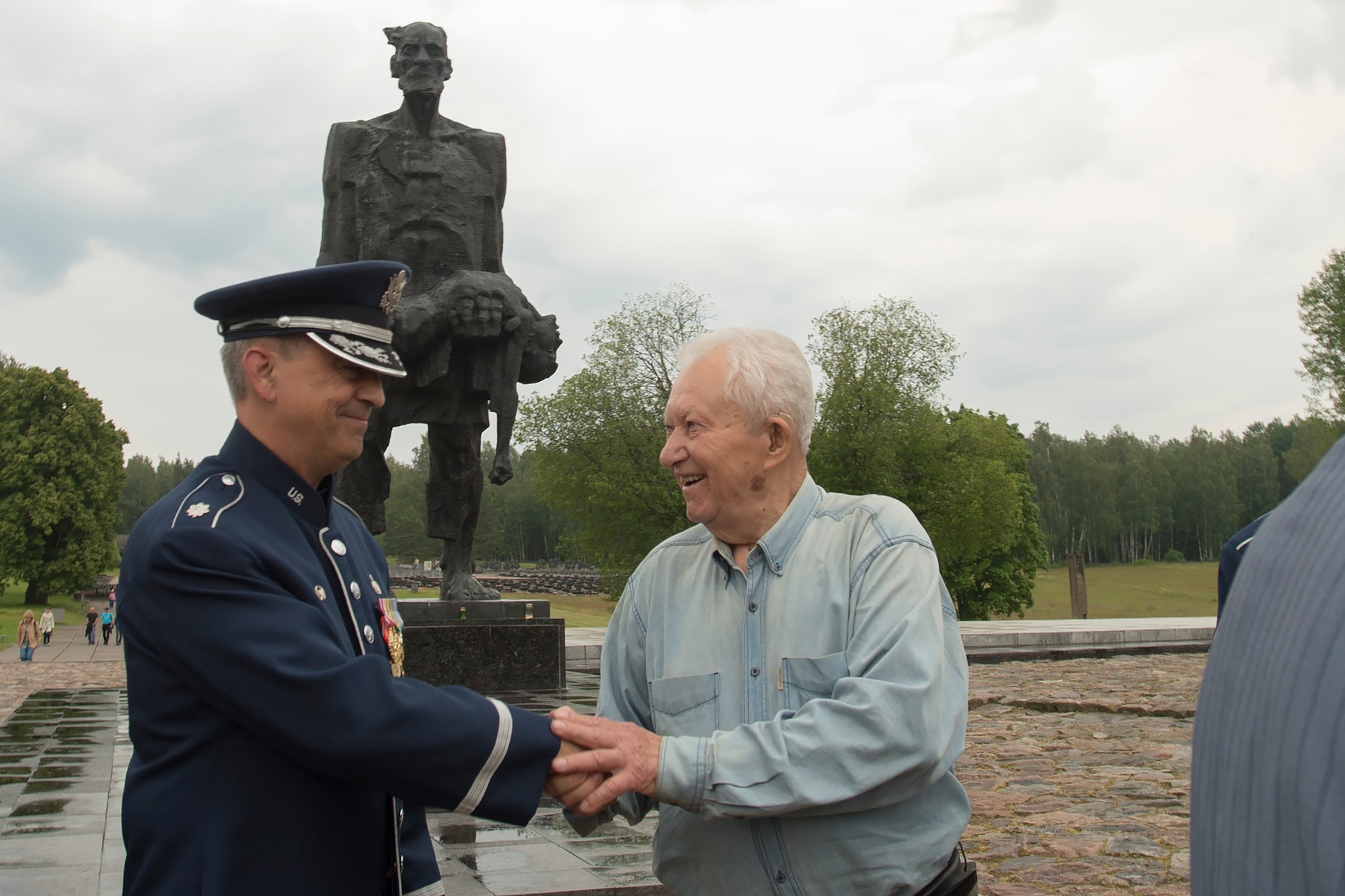Lt. Col. Mike Mench, U.S. Air Forces in Europe Band commander, talks with Grigory, former air force wing commander for the Soviet Union, June 20, 2016, in Khatyn Memorial, Belarus. Grigory talked with Mench about his service in the military and thanked him for coming to Belarus. While in Belarus, 13 bandsmen performed at events in Minsk and surrounding communities. (U.S. Air Force photo/Technical Sgt. Paul Villanueva II)