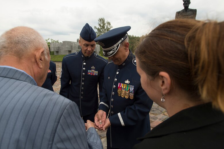 U.S. Air Force Lt. Col. Mike Mench, U.S. Air Forces in Europe Band commander, receives a commemorative pin from Vladimir Yarygin, a former submariner for the Soviet Union, June 20, 2016, in Khatyn Memorial, Belarus. Yarygin said he was overwhelmed with happiness and had given Mench the pin to thank him for visiting the memorial. While in Belarus, 13 bandsmen performed at events in Minsk and surrounding communities. The United States, Belarus, and other ally and partner nations continue to remember and honor shared World War II sacrifices. (U.S. Air Force photo/Technical Sgt. Paul Villanueva II)