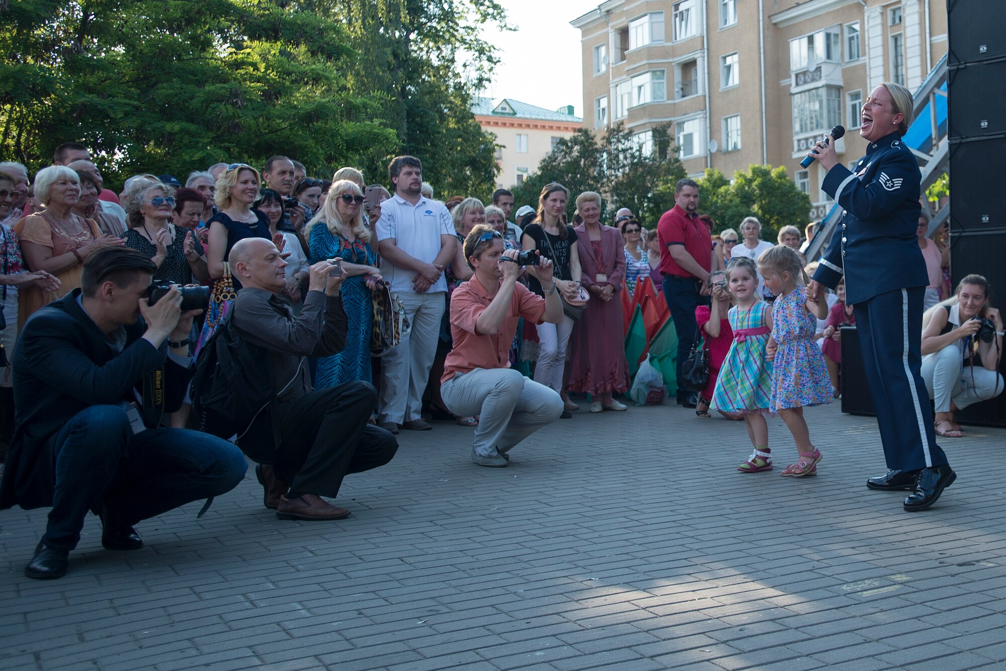 U.S. Air Force Staff Sgt. Jill Diem sings and dances with children during a performance with the the U.S. Air Forces in Europe Band’s Ambassadors Jazz Ensemble June 19, 2016 in Mogilev, Belarus. While in Belarus, 13 bandsmen performed in Minsk and surrounding communities. (U.S. Air Force photo/Technical Sgt. Paul Villanueva II)