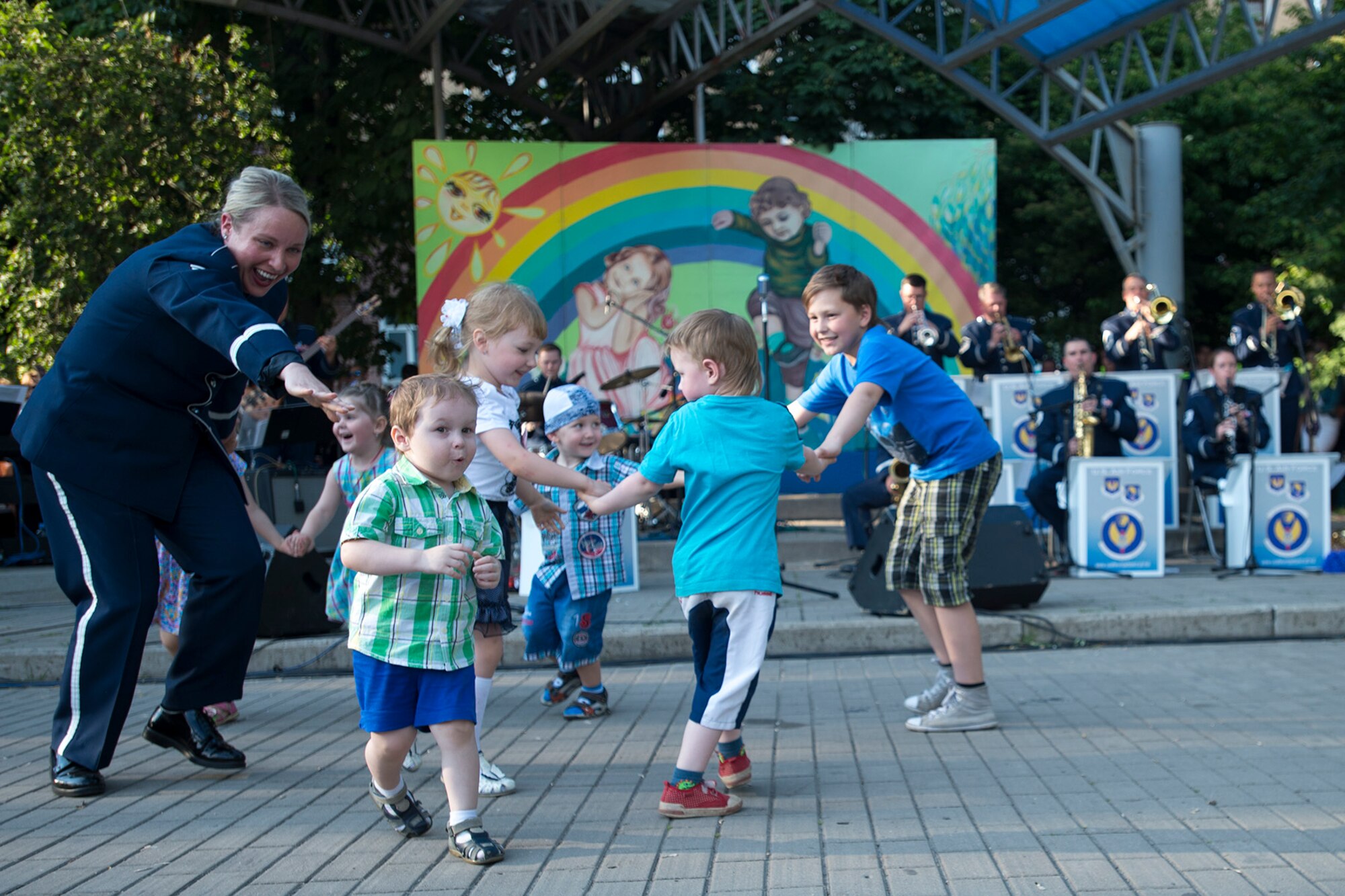 U.S. Air Force Staff Sgt. Jill Diem, U.S. Air Forces in Europe Band’s Ambassadors Jazz Ensemble vocalist, dances with children during a performance June 19, 2016, in Mogilev, Belarus. While in Belarus, 13 bandsmen performed in Minsk and surrounding communities to commemorate the alliance that ended the greatest conflict of the 20th Century. (U.S. Air Force photo/Technical Sgt. Paul Villanueva II)