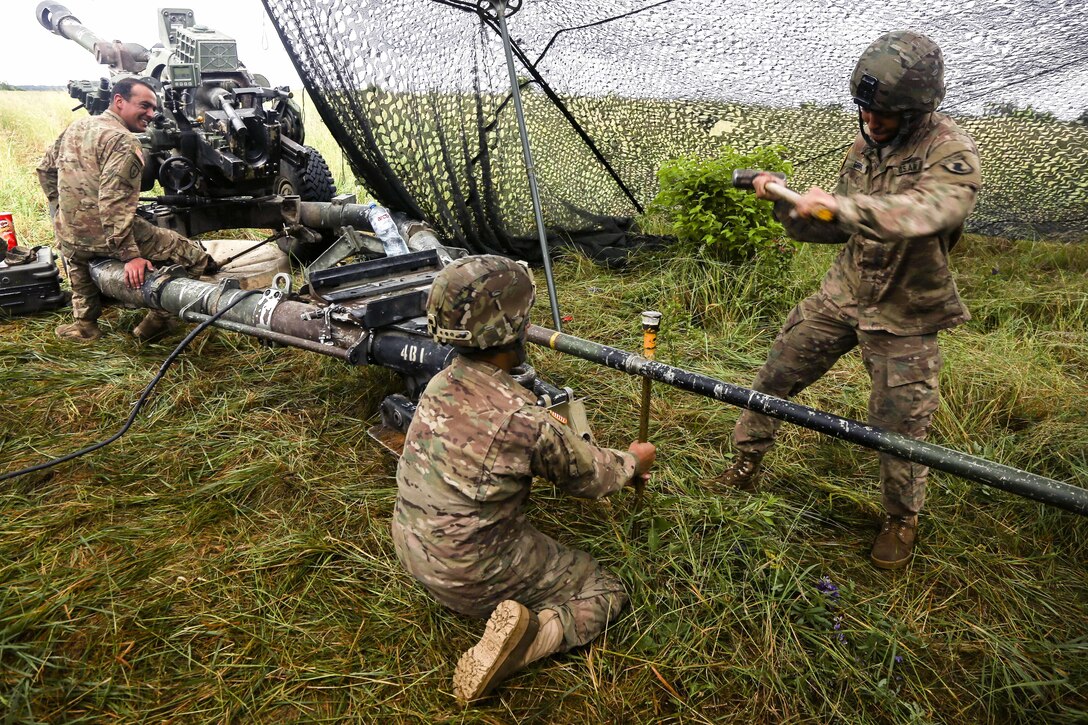 Soldiers hammer stakes into the ground for a M198 howitzer during Anakonda 2016 in Drawsko Pomorskie, Poland, June 14, 2016. The soldiers are assigned to Company A, 319th Field Artillery. Anakonda 2016 is a multinational exercise involving troops from more than 20 nations. Army photo by Pfc. Antonio Lewis