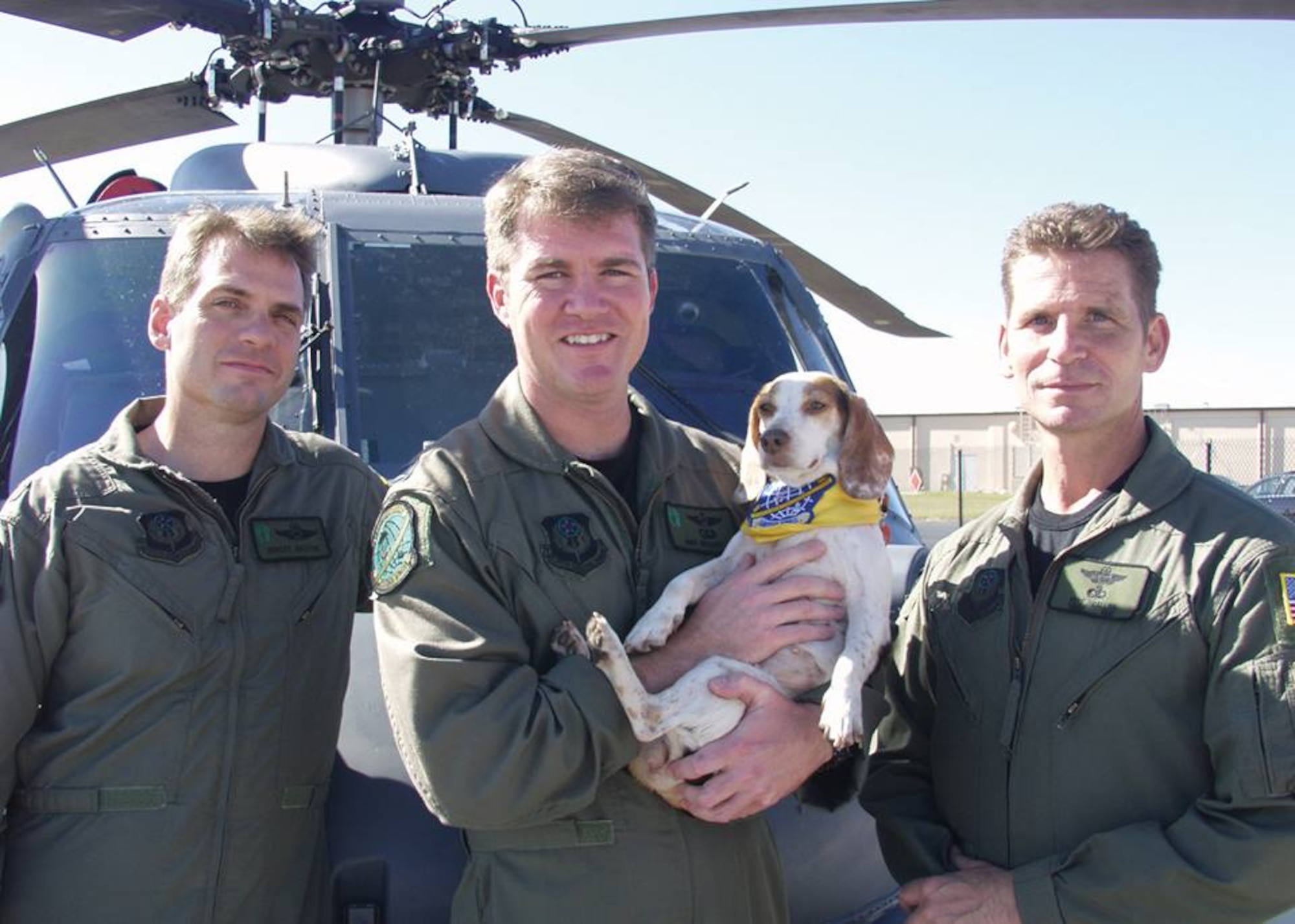 PATRICK AIR FORCE BASE, Fla.- 920th Rescue Wing members Maj. Robert Haston (left), Capt. Michael Brasher (center), and Senior Master Sgt. Pete Callina (right) pose with the brave beagle that aided their rescue efforts in New Orleans during Hurricane Katrina operations. Renamed "Katrina", the canine was reunited with the crew after Captain Brasher and his wife conducted their own search and rescue mission Dec. 3, 2015. (U.S. Air Force file photo/Senior Airman Heather L. Kelly) 