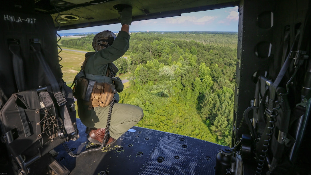 A crewman with Marine Light Attack Helicopter Squadron 167, 2nd Marine Aircraft Wing, helps guide a UH-1Y Venom as it approaches a landing zone during a training exercise near Marine Corps Base Camp Lejeune, N.C., June 17, 2016. Familiarization flights familiarize pilots new to the unit with the different landing zones and flight procedures around the Camp Lejeune area. 