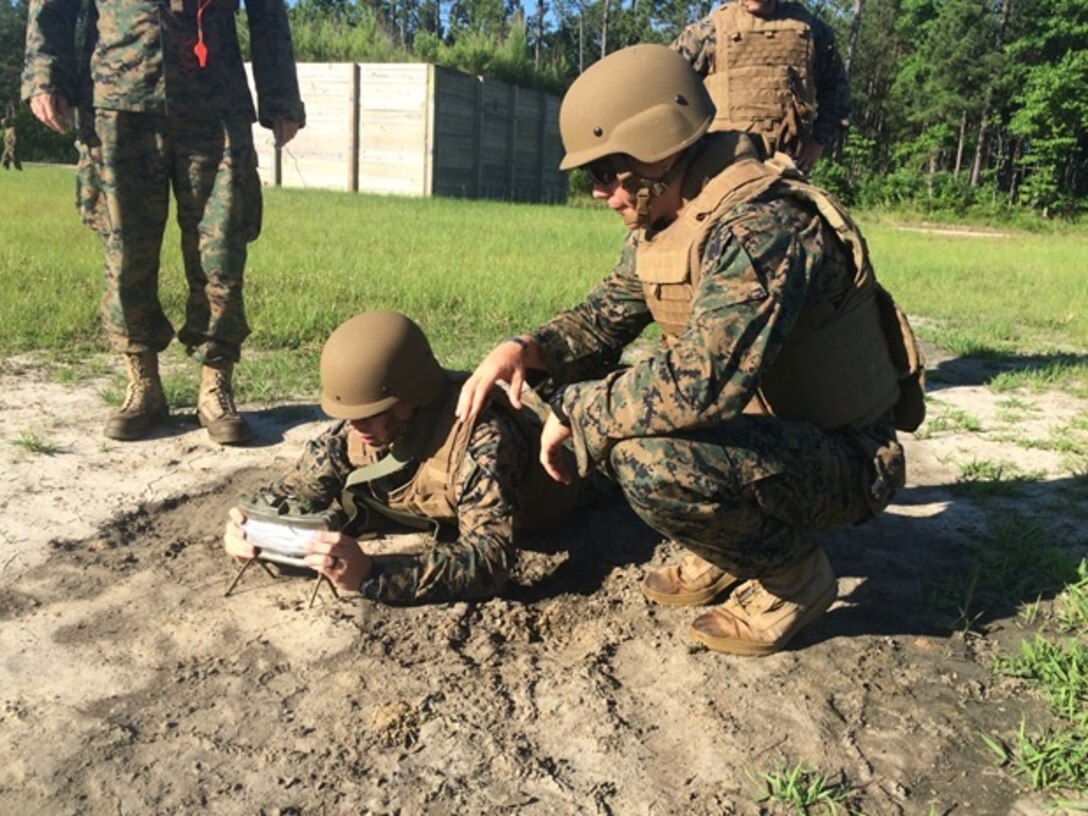 On June 9, 2016 Second Lieutenants Troy Searcy (left) and Thomas Cofer (right), Marines attached to Combat Engineer Officer course 5-16 (CEO 5-16); emplace a Claymore Mine. CEO students receive training in a variety of explosive obstacles, including the claymore mine.
