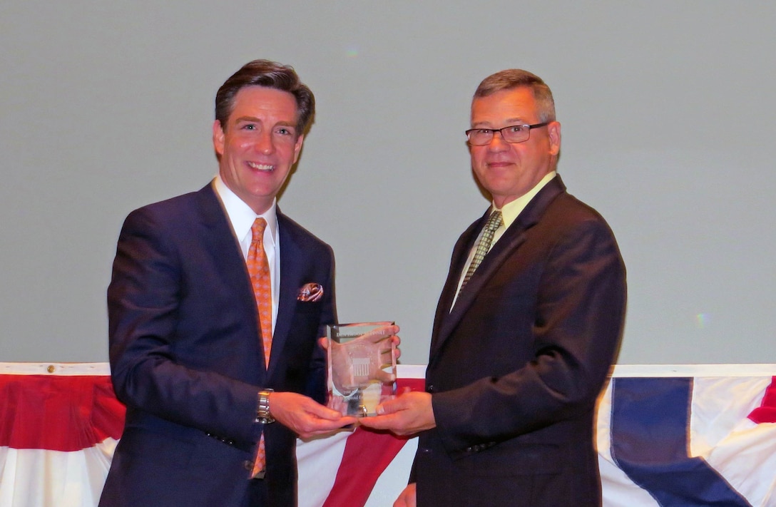 Jim Donovan, a co-anchor of CBS 3’s Eyewitness News This Morning, receives a plaque from DLA Troop Support Deputy Commander Richard Ellis as a thank you for being the keynote speaker at this year’s Lesbian, Gay, Bisexual and Transgender Pride Month program June 21. The Department of Defense theme for this year’s LGBT Pride Month is “Celebration.” 