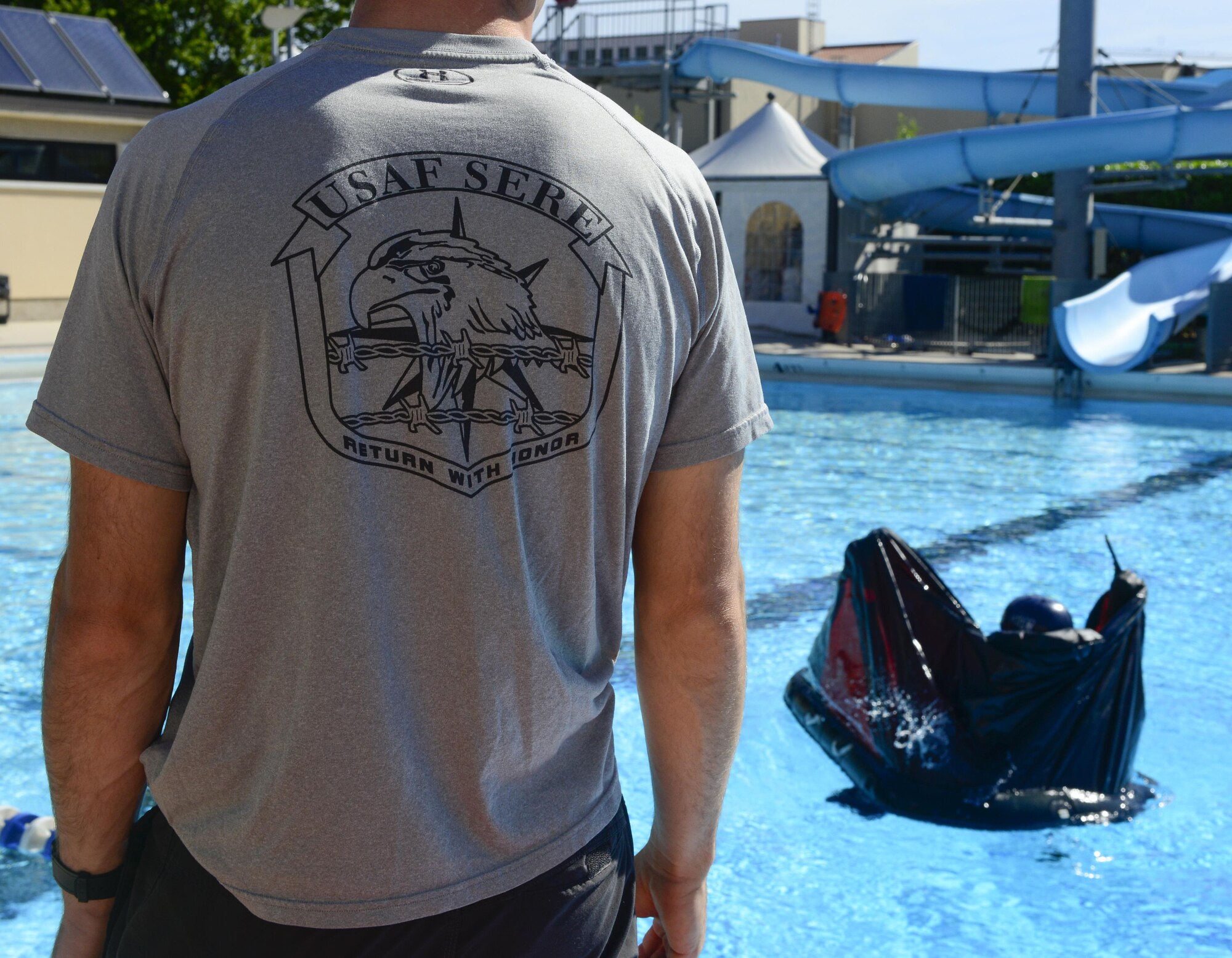 Tech. Sgt. Kevin Wilson, 31st Operations Support Squadron survival, evasion, resistance and escape instructor, observes a student enter a one-man life raft during a water survival training at Aviano Air Base, Italy, June 13, 2016. Wilson is one of two SERE specialists who provided annual refresher training to F-16 pilots. (U.S. Air Force photo by Senior Airman Krystal Ardrey/Released)