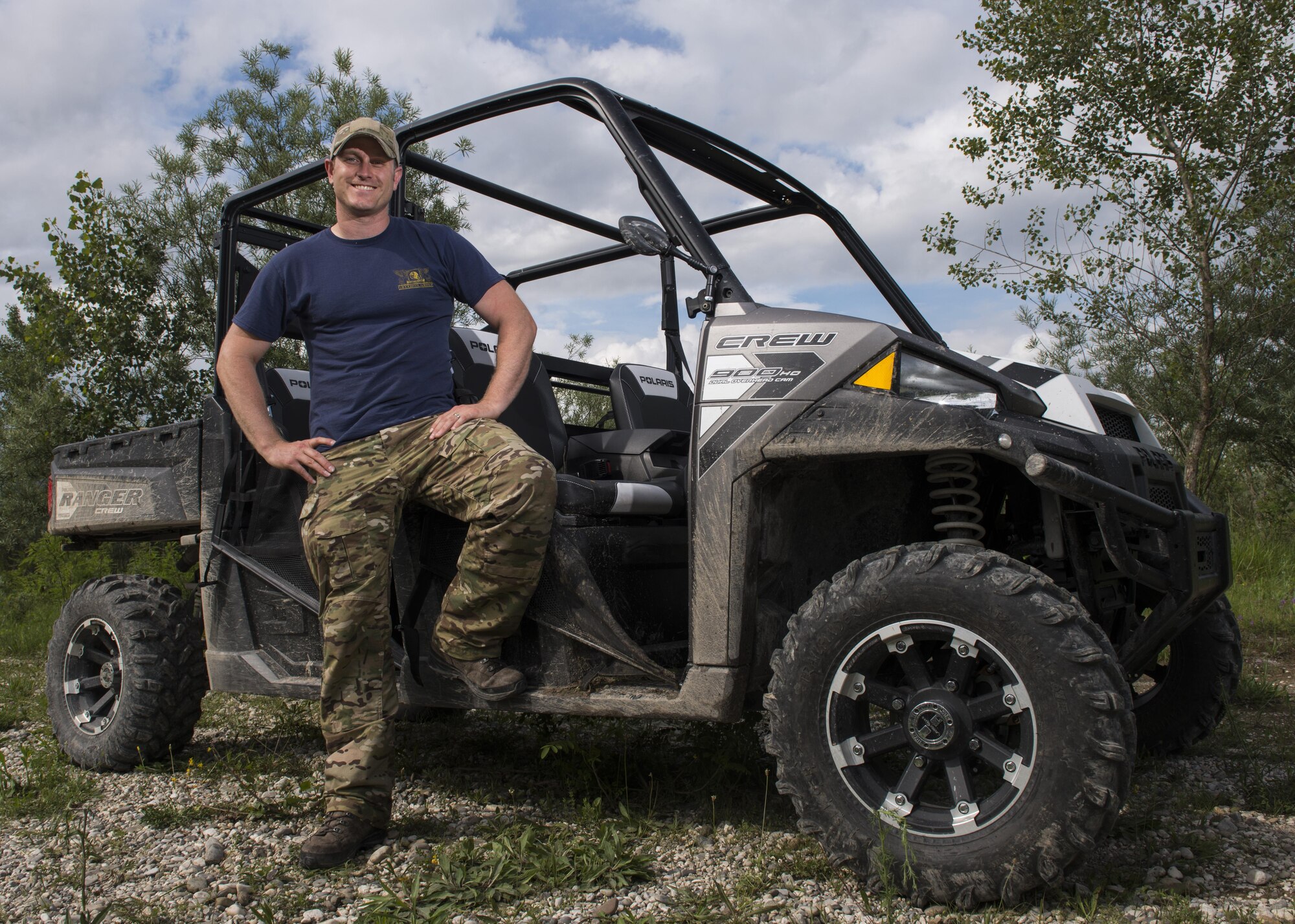 Tech. Sgt. H Jett, 31st Operations Support Squadron NCO in charge of survival, evasion, resistance and escape training, stands by a vehicle during a combat survival course outside of Spilimbergo, Italy, June 14, 2016. Jett is one of two instructors who teaches 555th and 510th Fighter Squadrons F-16 Fighting Falcon pilots SERE skills. (U.S. Air Force photo bvby Senior Airman Krystal Ardrey/Released)