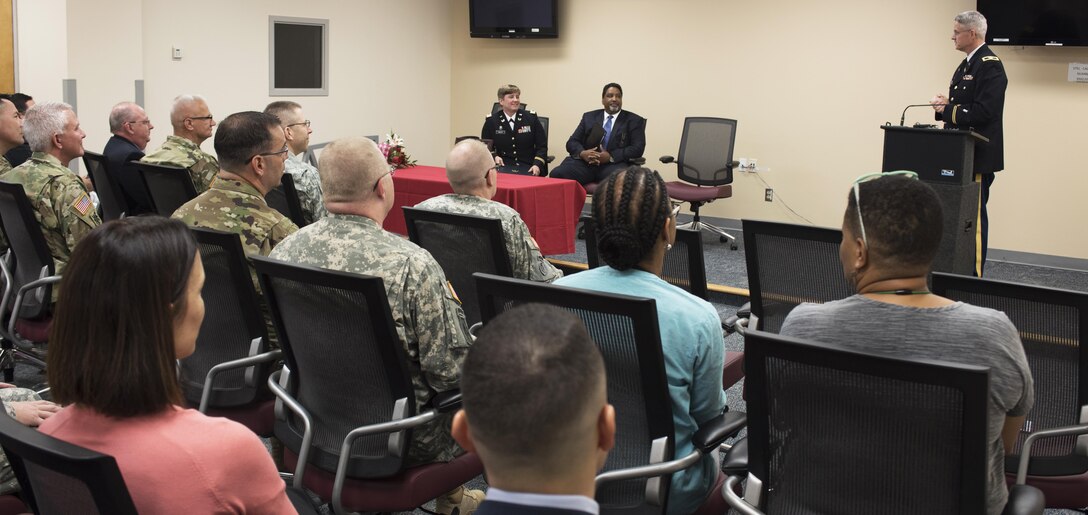 Col. Christopher Headrick, the 80th Training Command’s Staff Judge Advocate, addresses the audience during a ceremony where Capt. Tanya Mayes, an administrative law and military justice attorney assigned to the 80th Training Command, received the 2015 American Bar Association’s Legal Assistance for Military Personnel Distinguished Service Award. Retired Navy Captain Dwain Alexander, (seated next to Mayes) a member of the ABA LAMP committee, presented Mayes with the award at the Hunter Holmes McGuire VA Medical Center June 10, 2016. Mayes was recognized for leading an effort to establish a free legal assistance clinic for military veterans after she learned that a significant number of patients needed assistance.
