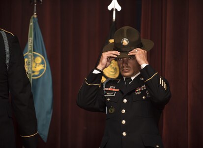 Graduates of the Drill Sergeant Course are each presented with their Drill Sergeant hats at a graduation ceremony held at the Post Theater on Fort Jackson, S.C., June 22. (U.S. Army photo by Sgt. 1st Class Brian Hamilton/ released)