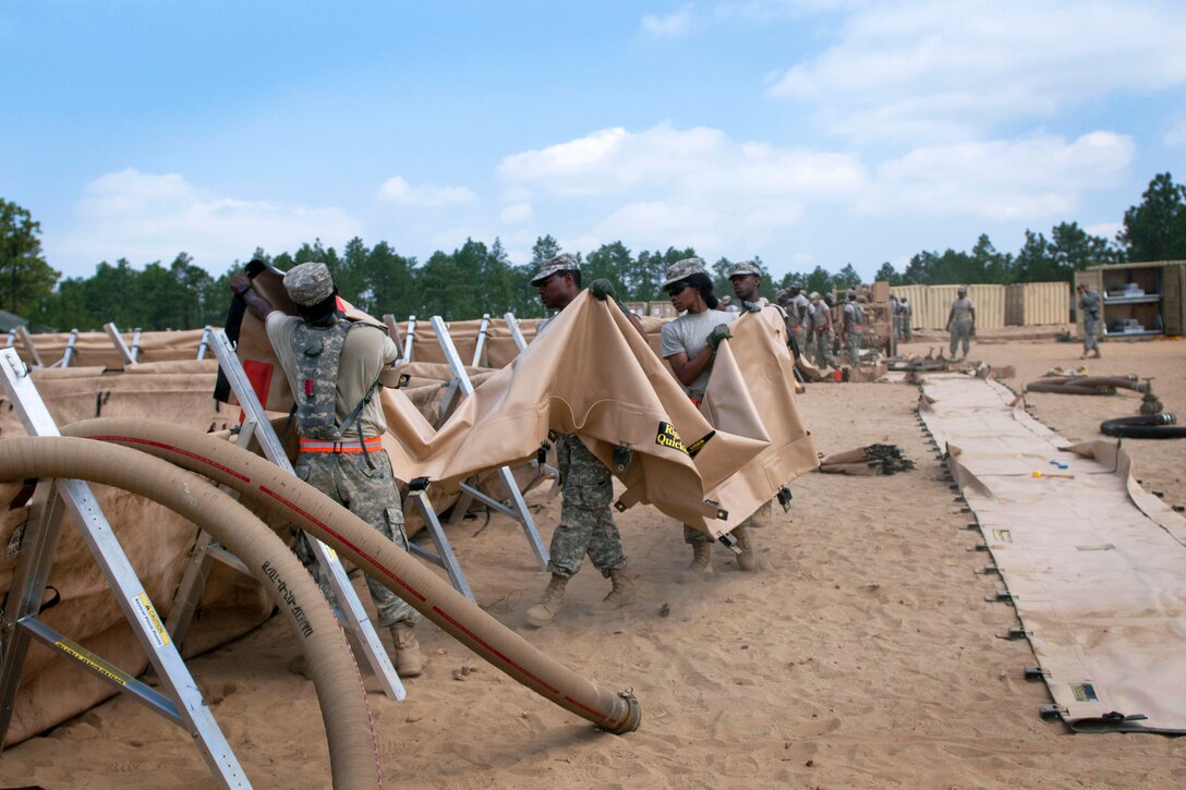 Soldiers setup spill guards in case of any fuel spillage during the annual Quartermaster Liquid Logistics Exercise at Fort Bragg, N.C., June 14, 2016. Army photo by Staff Sgt. Dalton Smith