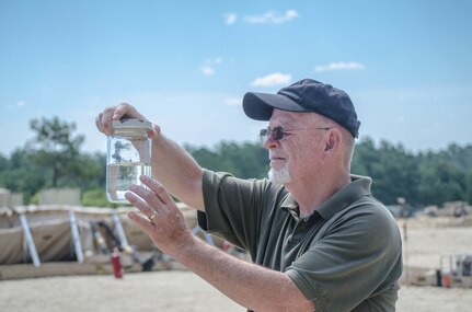 FORT BRAGG, N.C. - Michael Purkey, quality assurance specialist, from Defense Logistics Agency Energy Americas East checks a sample of recirculated fuel given to him by members of the 894th Quartermaster Company during the 2016 Quartermaster Liquid Logistics Exercise on Fort Bragg. DLA contractors manage, stock, store, distribute, deal with contracting, acquisition, and fuel for the Department of Defense. (U.S. Army photo by Sgt. William Battle, 372nd Mobile Public Affairs Detachment)