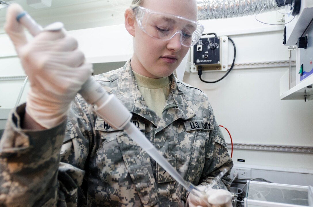 FORT BRAGG, N.C. - Pvt. Rachel Hammond of the 319th Quartermaster Battalion from Mansfield, Ohio, prepares a fuel sample for mini flash point testing to calculate the lowest temperature at which the vapors of the material will ignite, given an ignition source. The various types of fuel used by the military have different flash points and this test would be used to determine the type of fuel if it is sample from an unknown source. By determining the flash point of fuel and other chemicals, guidelines can also be written for safe and proper storage of the materials. (U.S. Army photo by Sgt. William Battle, 372nd Mobile Public Affairs Detachment)