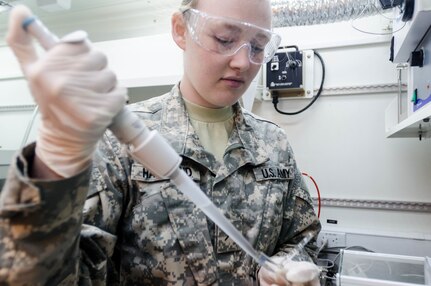 FORT BRAGG, N.C. - Pvt. Rachel Hammond of the 319th Quartermaster Battalion from Mansfield, Ohio, prepares a fuel sample for mini flash point testing to calculate the lowest temperature at which the vapors of the material will ignite, given an ignition source. The various types of fuel used by the military have different flash points and this test would be used to determine the type of fuel if it is sample from an unknown source. By determining the flash point of fuel and other chemicals, guidelines can also be written for safe and proper storage of the materials. (U.S. Army photo by Sgt. William Battle, 372nd Mobile Public Affairs Detachment)