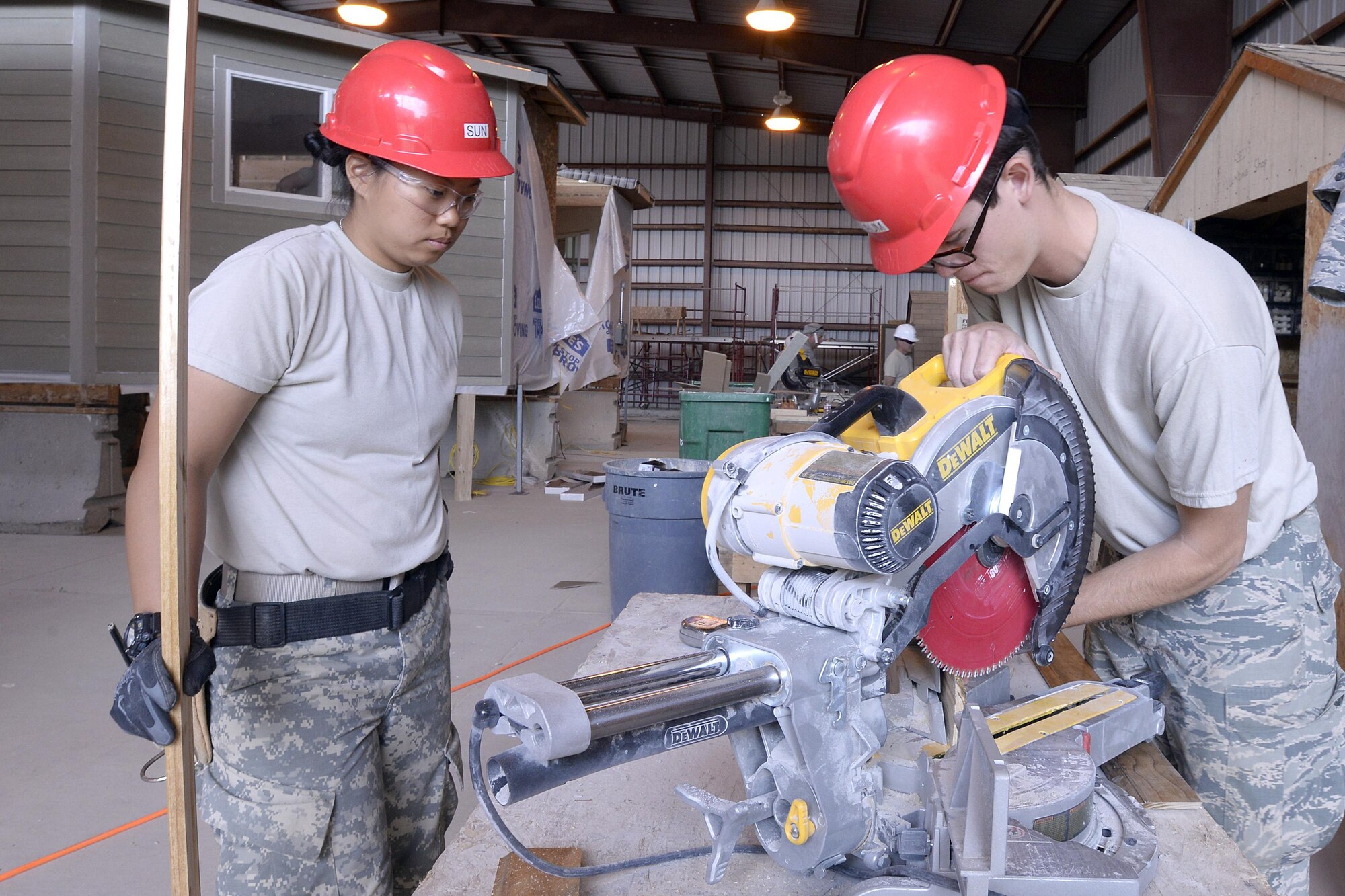 Cadets at the U.S. Air Force Academy use a saw while building two homes for the Navajo Nation June 22, 2016.
The cadets are participating in the Academy's Field Engineering and Readiness Laboratory, a five-week summer course for civil and environmental engineering majors at the school. (U.S. Air Force photo/Mike Kaplan)