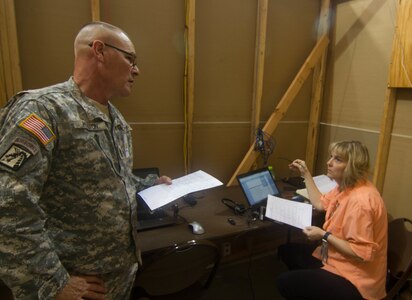 FORT A.P. HILL, Va. - Sgt. Maj. Larry Houston, left, discusses missions with Defense Logistics Agency representative Shona Lawrence at the 2016 Quartermaster Liquid Logistics Exercise, a training exercise in which almost 700 Army Reserve Soldiers of the 745th Quartermaster Group provide fuel and water to military installations. (U.S. Army photo by Spc. Gary R. Yim)