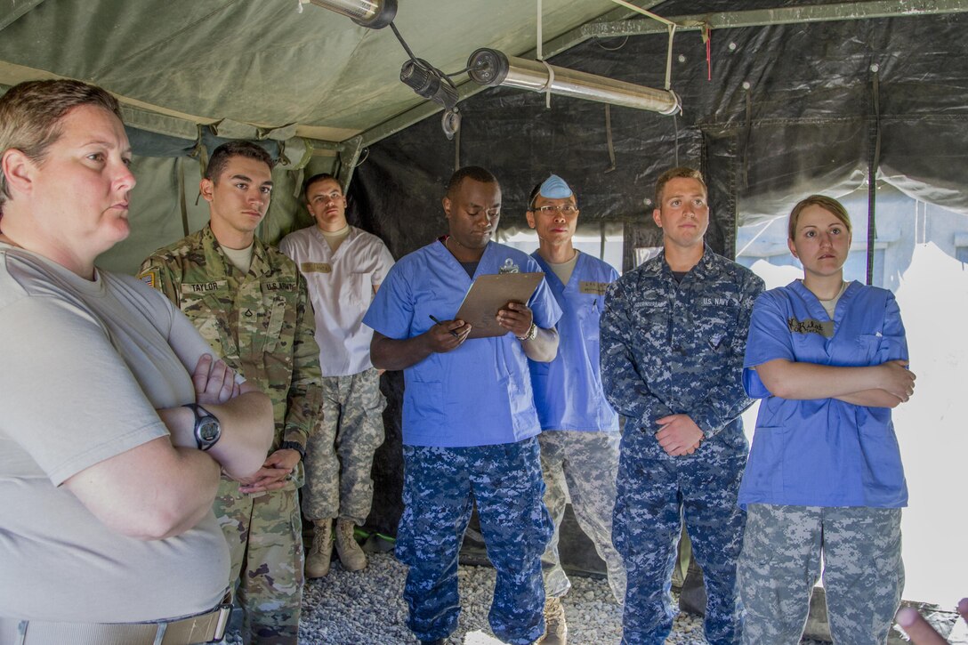 U.S. Army Reserve Soldiers, 325th Combat Support Hospital, Springfield, Mo., and U.S. Navy Reserve Sailors, Expeditionary Medical Facility Dallas One, Fort Worth, Texas, listen to a class on medical equipment at the 325th Combat Support Hospital during Combat Support Training Exercise 91-16-02, Fort Hunter Liggett, Calif., June 18, 2016. As the largest U.S. Army Reserve training exercise, CSTX 91-16-02 provides Soldiers with unique opportunities to sharpen their technical and tactical skills in combat-like conditions. (U.S. Army photo by Spc. Fatima Konteh, 367th Mobile Public Affairs Detachment)