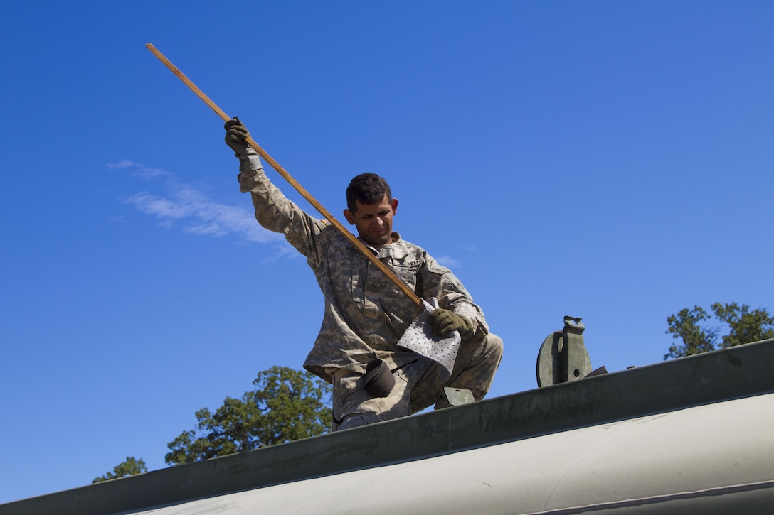 U.S. Army Reserve Pvt. Manuel Morgan, 1017th Quartermaster Company, Camp Pendleton, Calif., gauges the amount of fuel remaining in a M969 at Tactical Assembly Area Schoonover during Combat Support Training Exercise 91-16-02 on June 20, 2016, Fort Hunter Liggett, Calif. As the largest U.S. Army Reserve training exercise, CSTX 91-16-02 provides Soldiers with unique opportunities to sharpen their technical and tactical skills in combat-like conditions. (U.S. Army photo by Sgt. Krista L. Rayford, 367th Mobile Public Affairs Detachment)