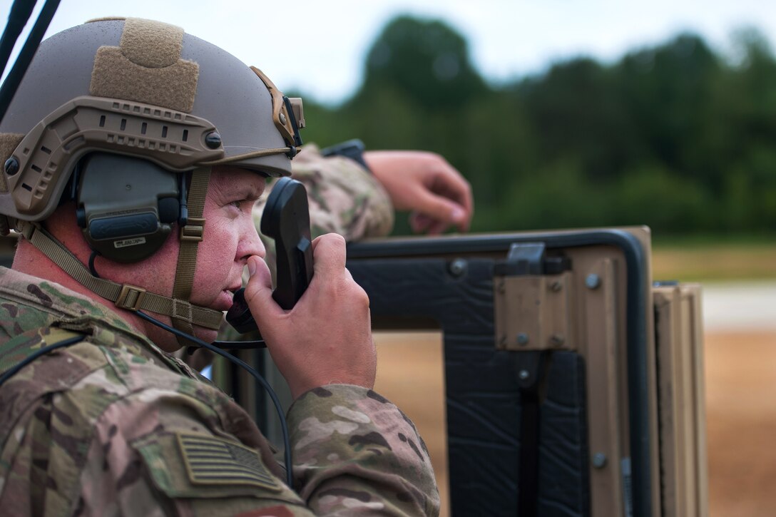 Air Force Maj. Aaron Cook communicates with a C-130J Super Hercules pilot during Exercise Swift Response 16 in Hohenfels, Germany, June 16, 2016. Cook is a liaison officer assigned to the 621st Mobility Support Operations Squadron Air Mobility. Air Force photo by Master Sgt. Joseph Swafford