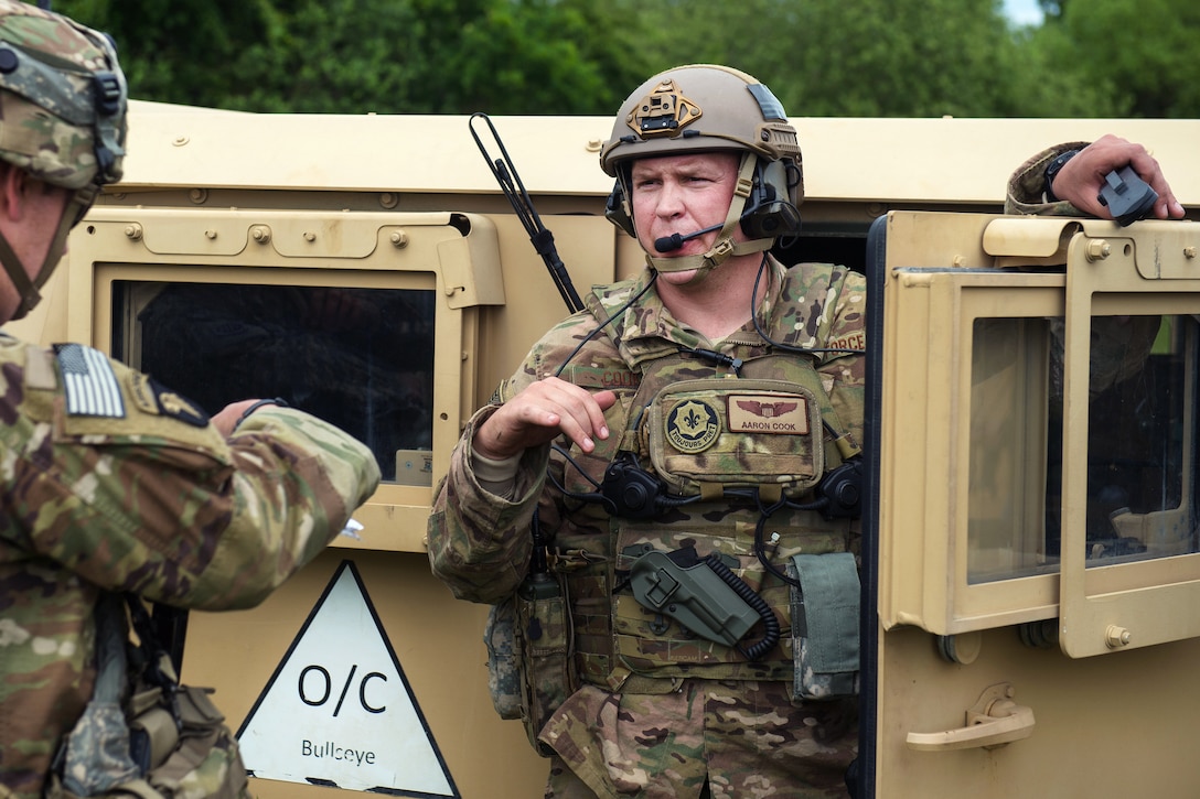 Air Force Maj. Aaron Cook, right, talks with a soldier during Exercise Swift Response 16 in Hohenfels, Germany, June 16, 2016. Cook is a liaison officer assigned to the 621st Mobility Support Operations Squadron Air Mobility. The soldier is assigned to the 82nd Airborne Division. Air Force photo by Master Sgt. Joseph Swafford