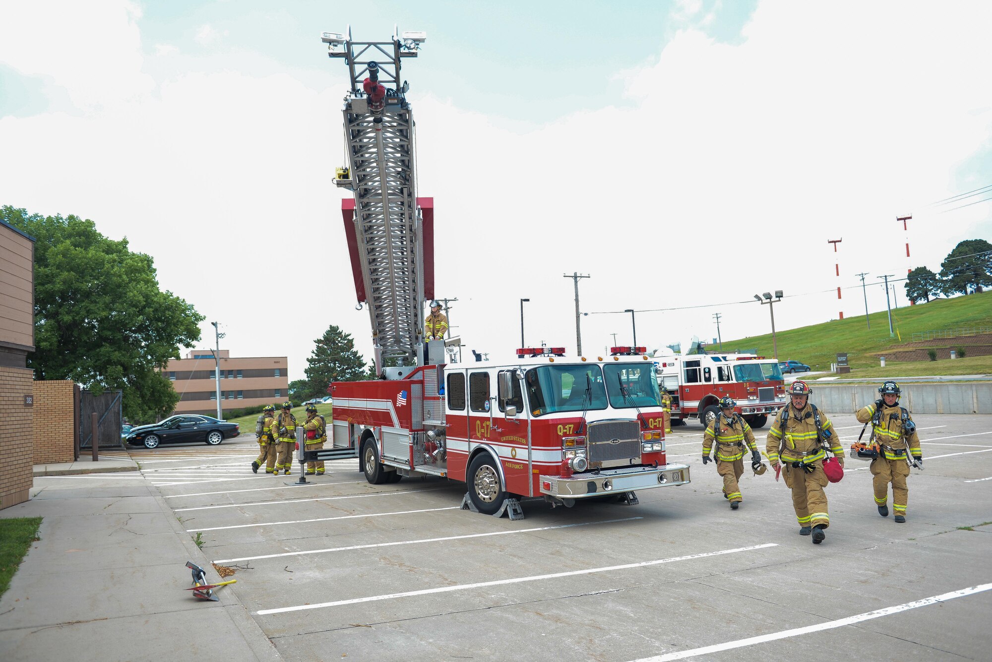 Firefighters assigned to the 55th Civil Engineer Squadron, prepare to respond to a training exercise at building 382 at Offutt Air Force Base, Neb. June 21, 2016. Fire protection specialists train nearly every day on different aspects of their jobs to ensure they are able and ready to respond to any type of emergency. (U.S. Air Force photo by Zachary Hada)